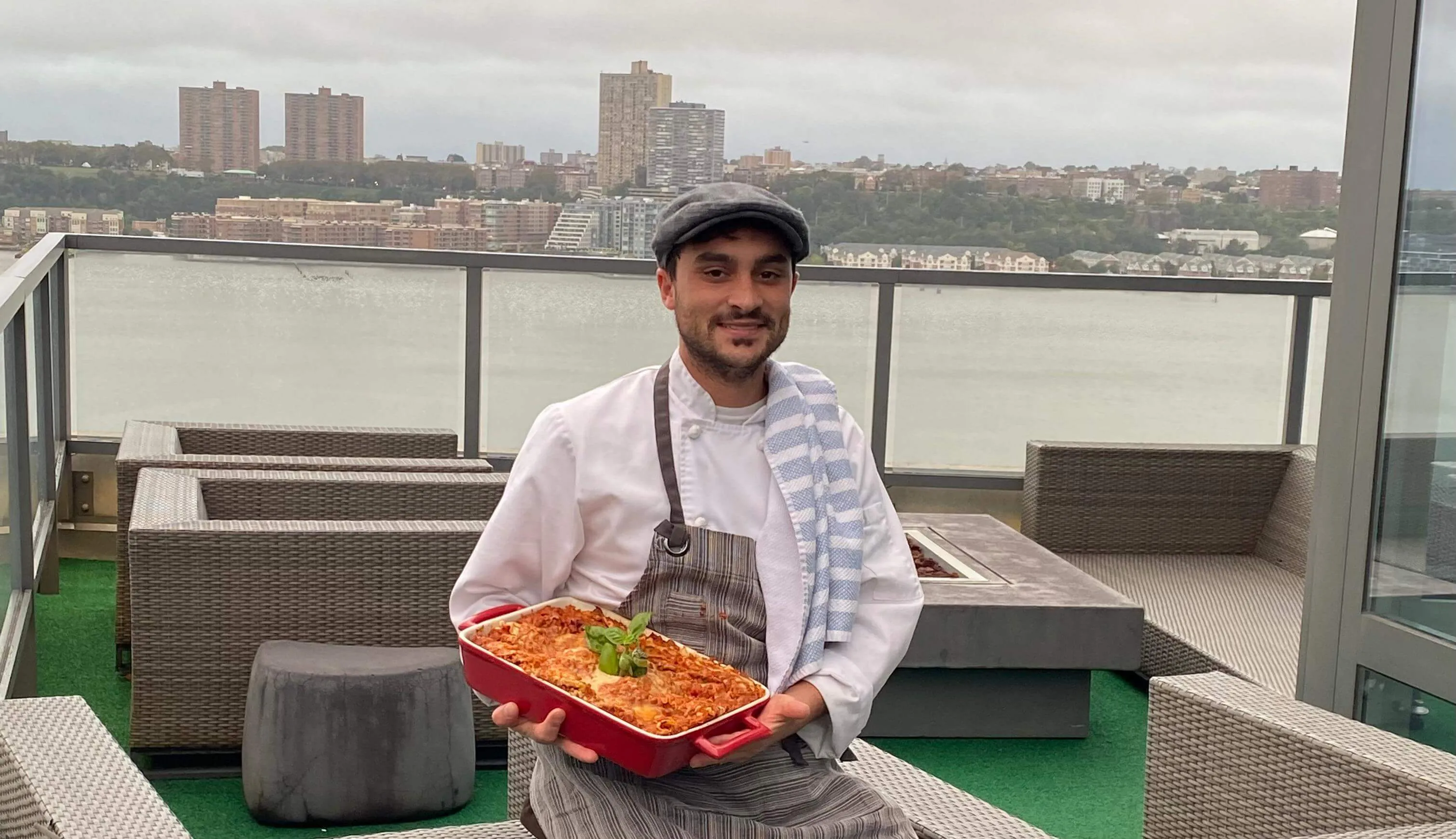 Chef Corrado Cervelli holding a dish of baked pasta