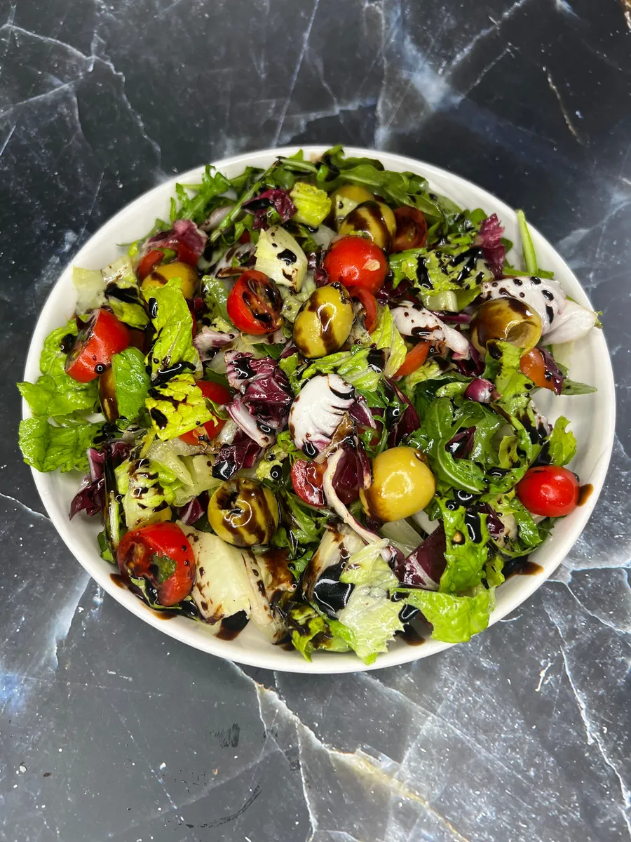 Insalata Tricolore with greens, cherry tomatoes and olives