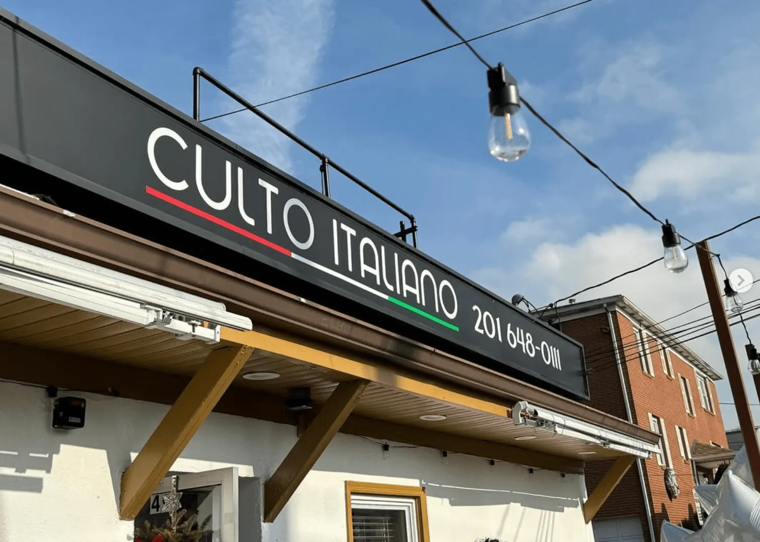 The Culto Italiano sign above the restaurant on W Church St