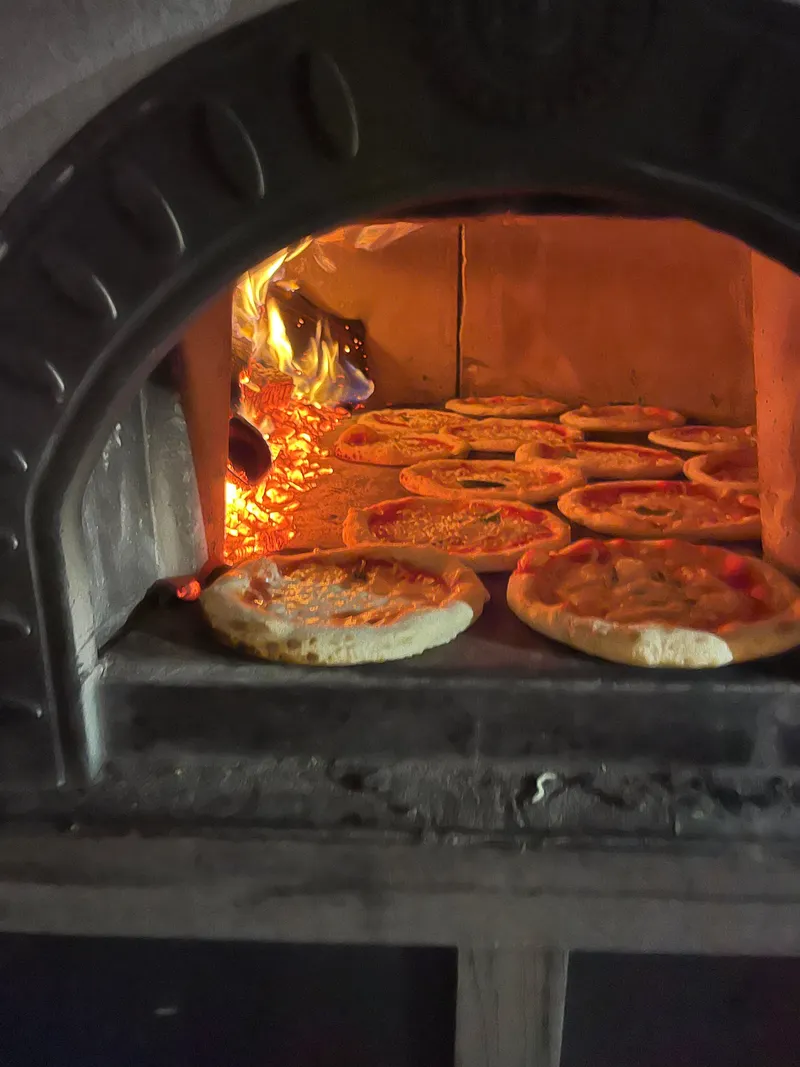 Pizzas baking in Culto Italiano's mobile wood-fired oven