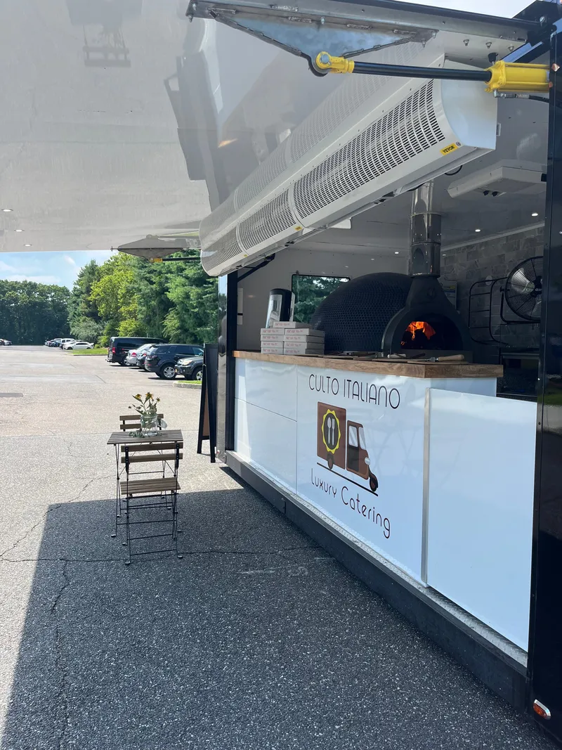 The wood-fired oven inside the open Pizza Truck